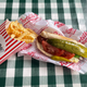 Portillo's plant-based hot dog and fries on checkerboard tablecloth